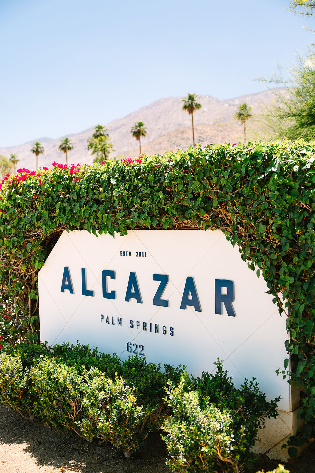 Details of the front vine covered alcazar palm springs wedding venue sign
