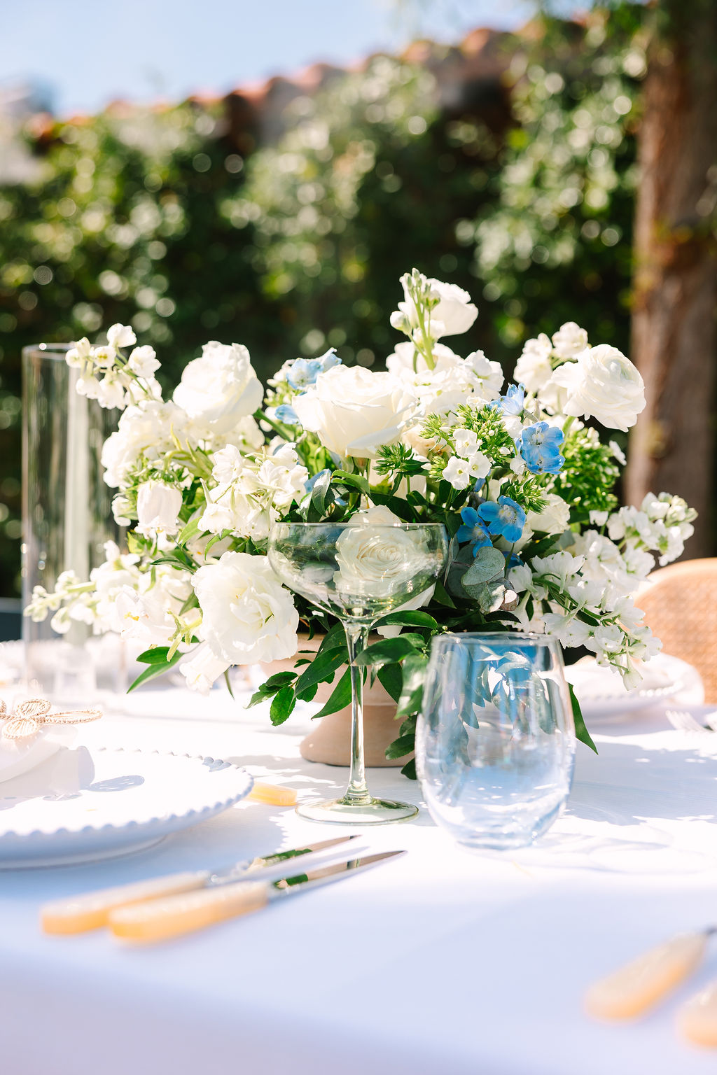 Details of a white and blue floral bouquet as a reception table centerpiece