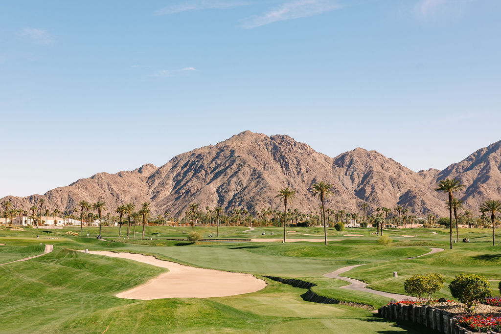 A view from the clubhouse of the pga west pete dye mountain course and mountains in the background