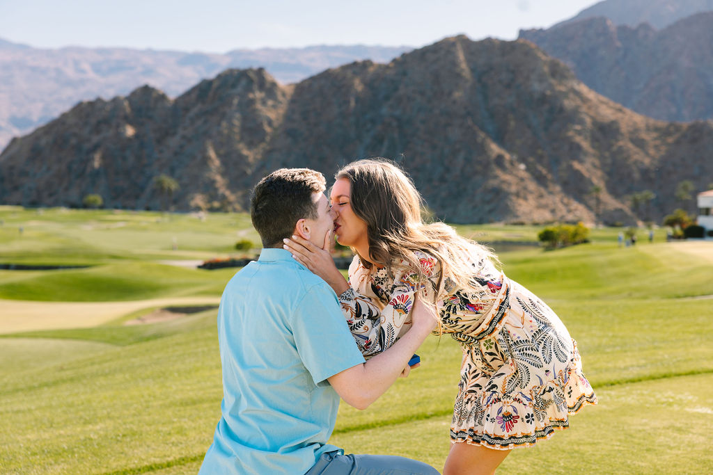 A newly engaged couple kisses