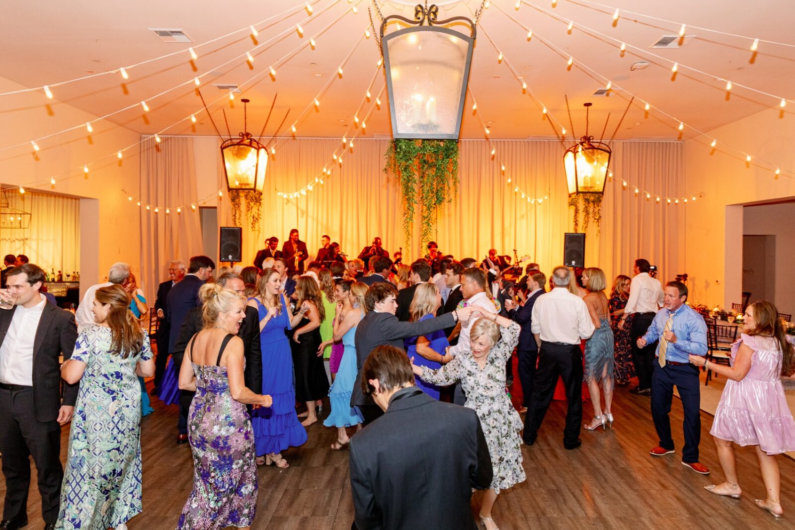 A look at a lively la quinta country club wedding reception with a live band and market lights