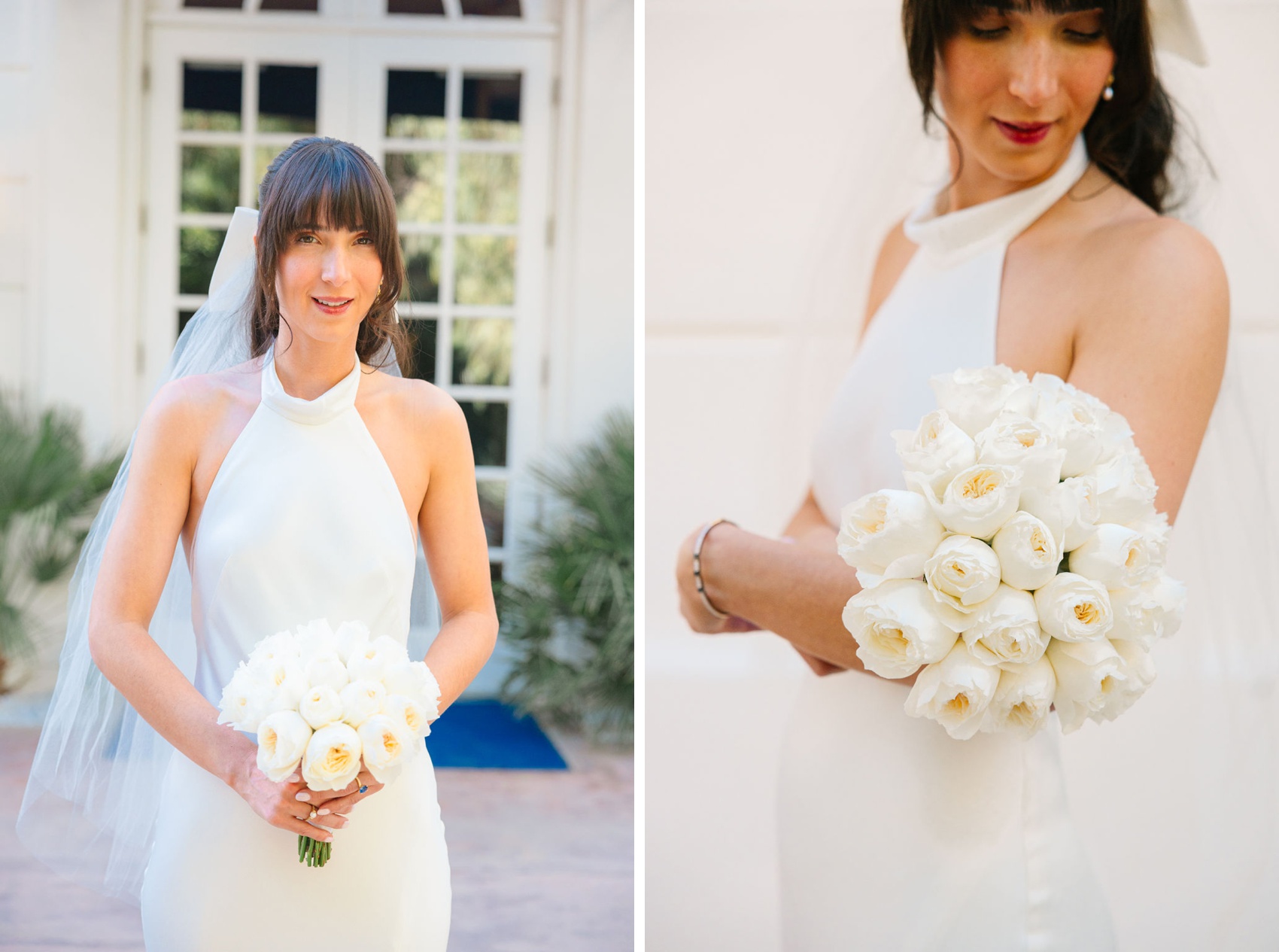 A bride smiles down at her all white rose bouquet in her hands