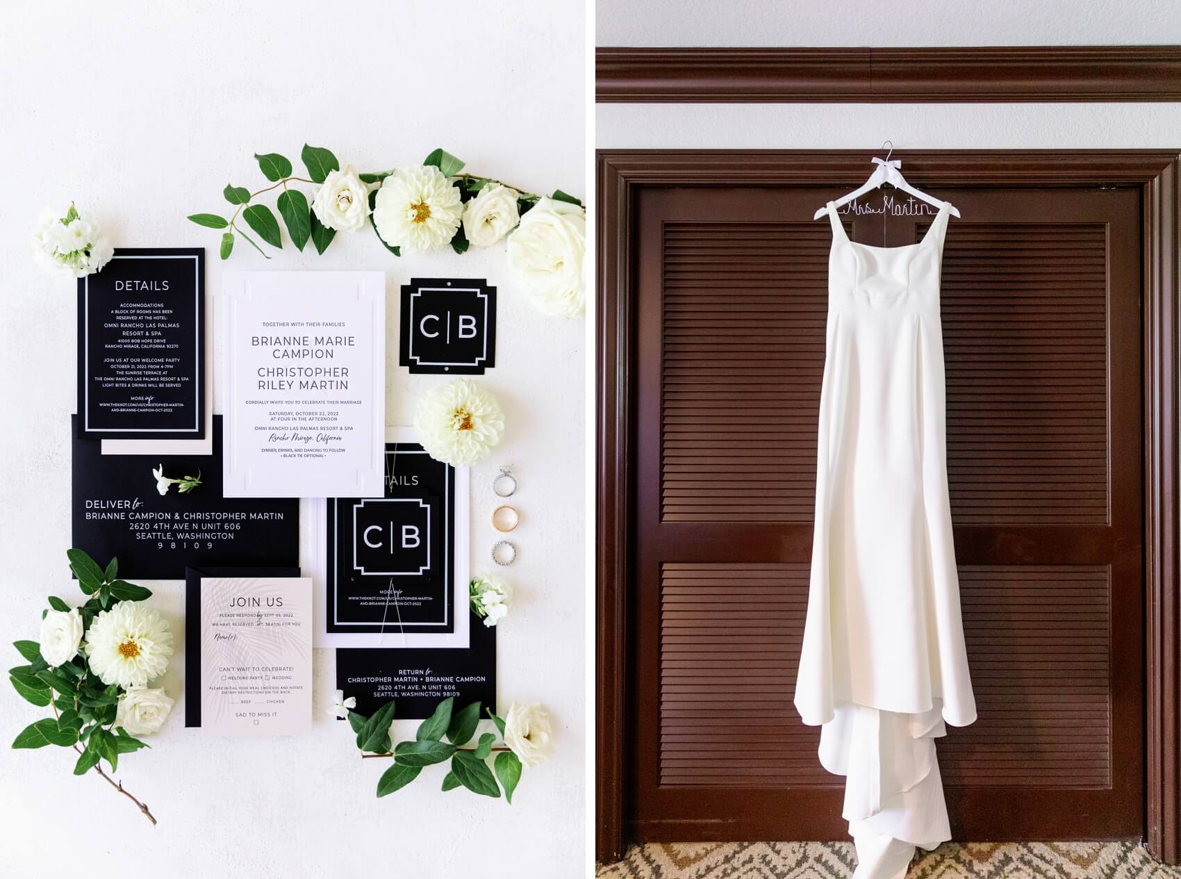 Details of wedding invitations, rings and white flowers next to the wedding dress hanging over a closet door