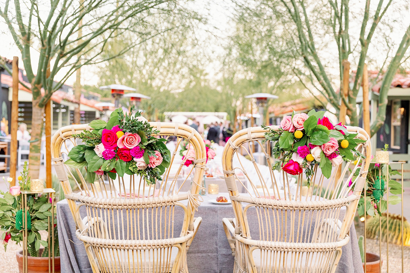 Details of newlyweds wicker chairs at a Fleur Noire Hotel wedding reception