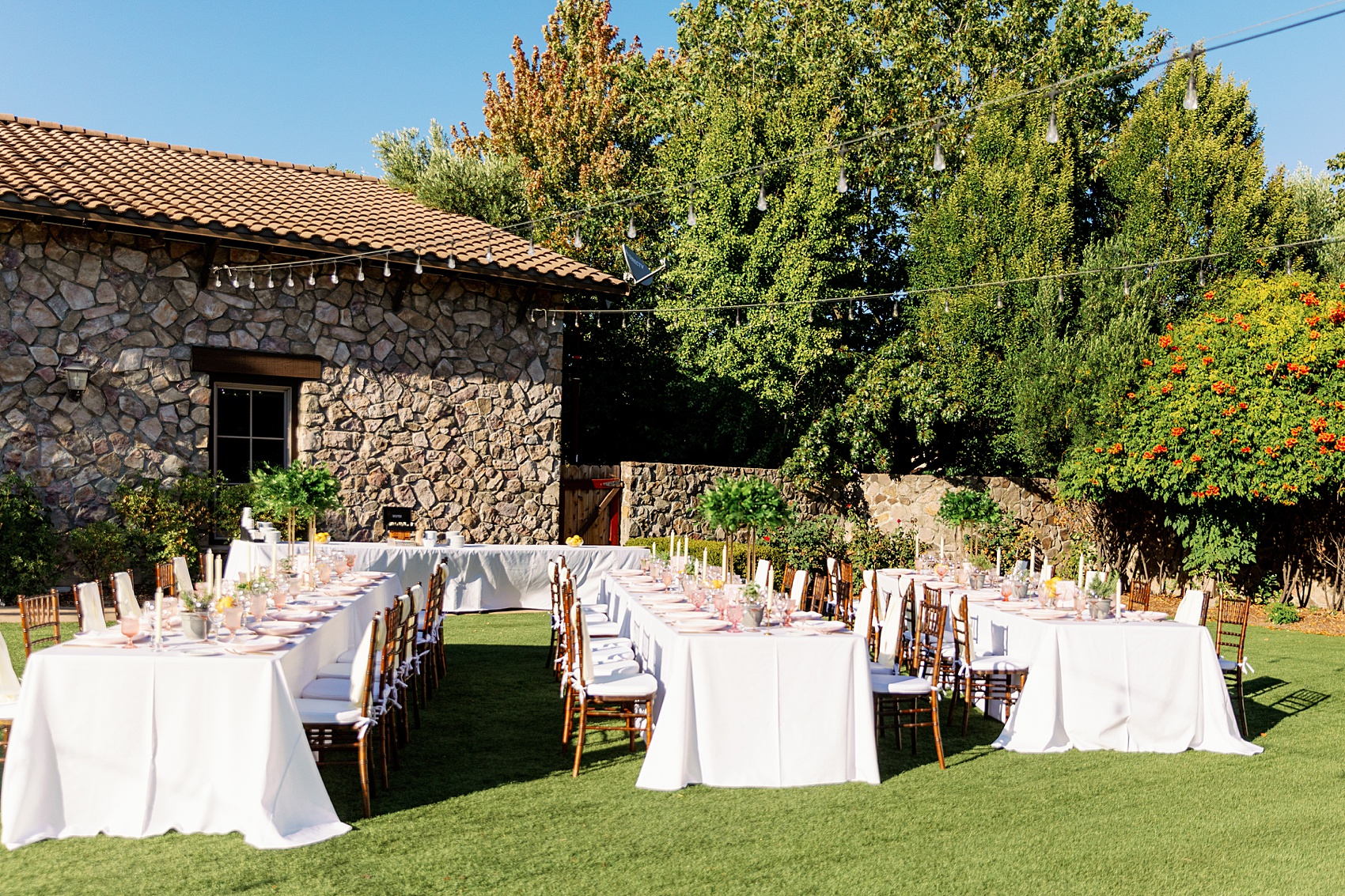 Details of an outdoor wedding reception set up in the lawn under market lights at the lodge at sonoma wedding