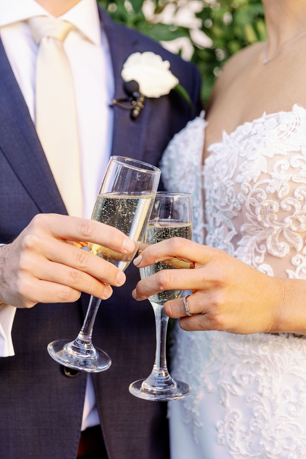 Details of newlyweds toasting champagne flutes
